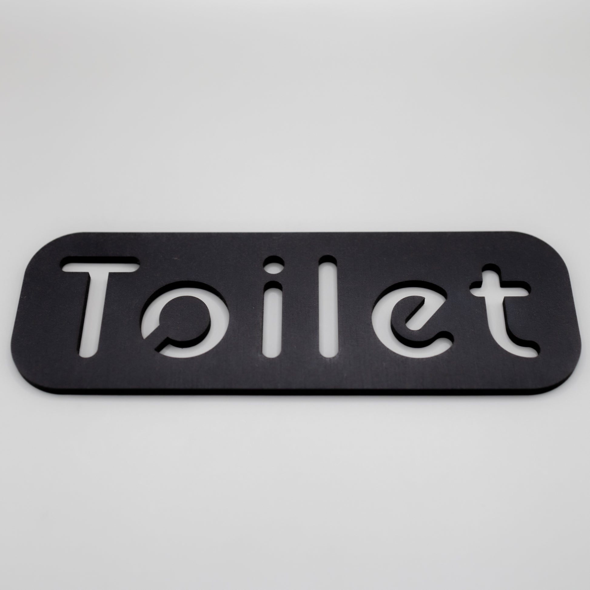 Self-adhesive toilet door marker