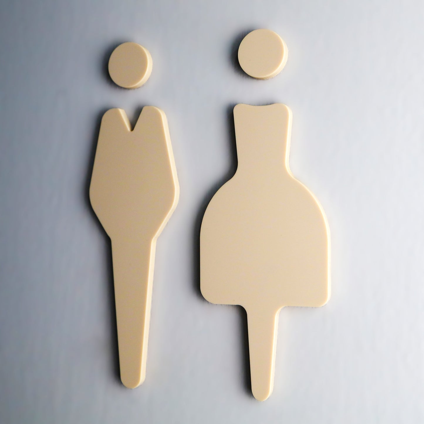 Self-adhesive bathroom sign with sleek design mounted on a wall