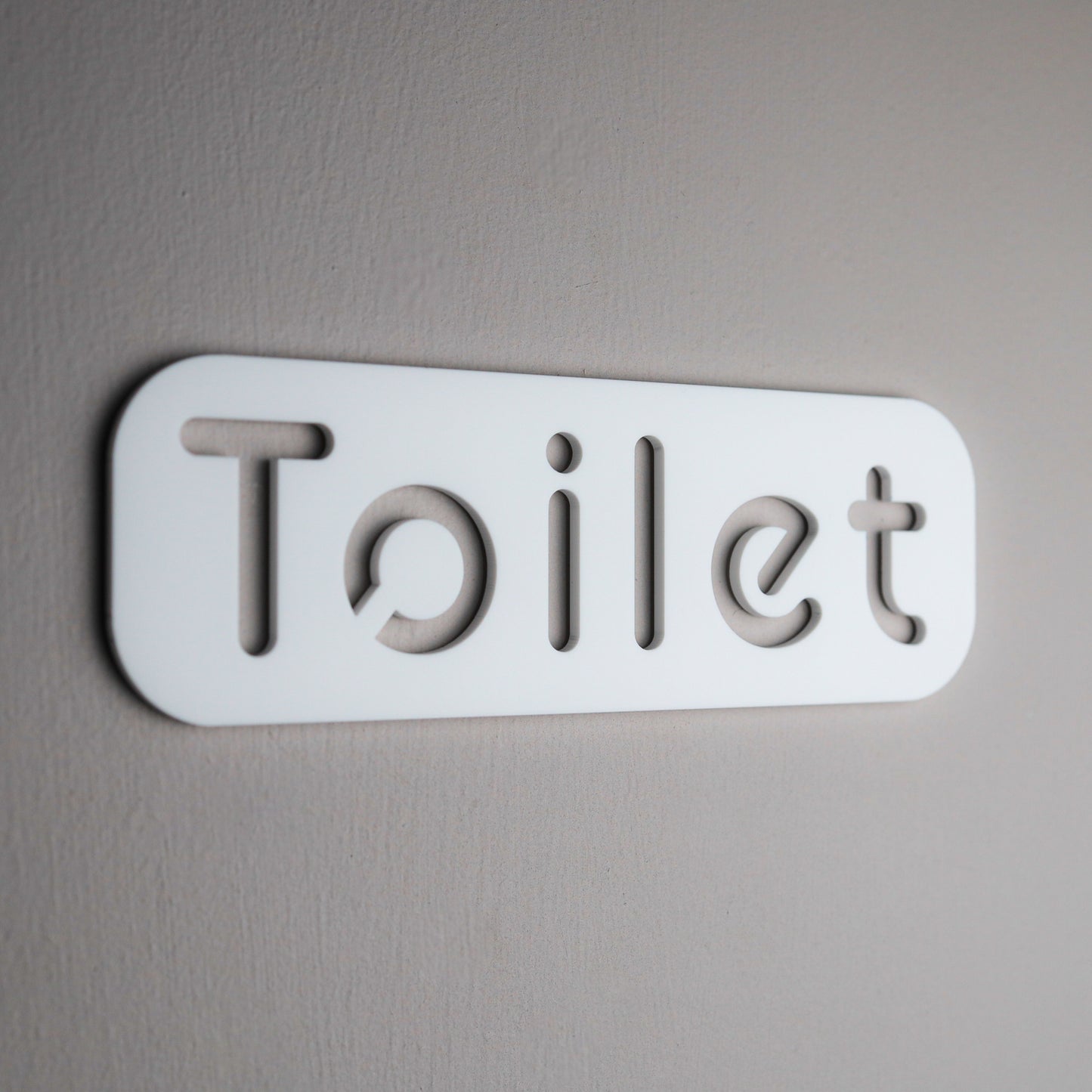 Sleek and stylish bathroom door sign with self-adhesive backing for easy installation.