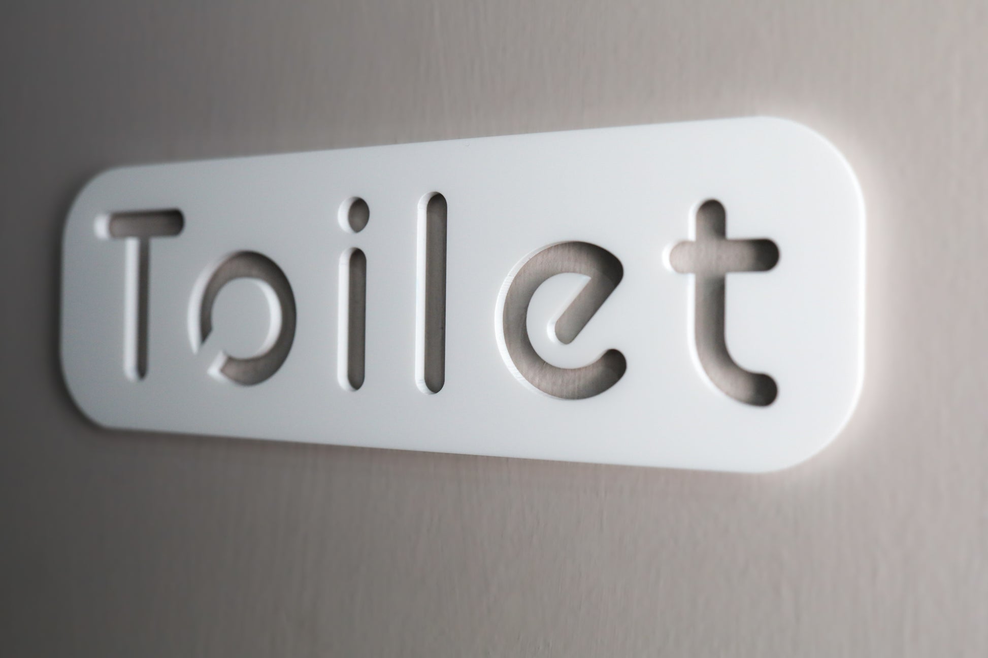 Simple yet chic white acrylic sign for bathroom doors with self-adhesive backing.