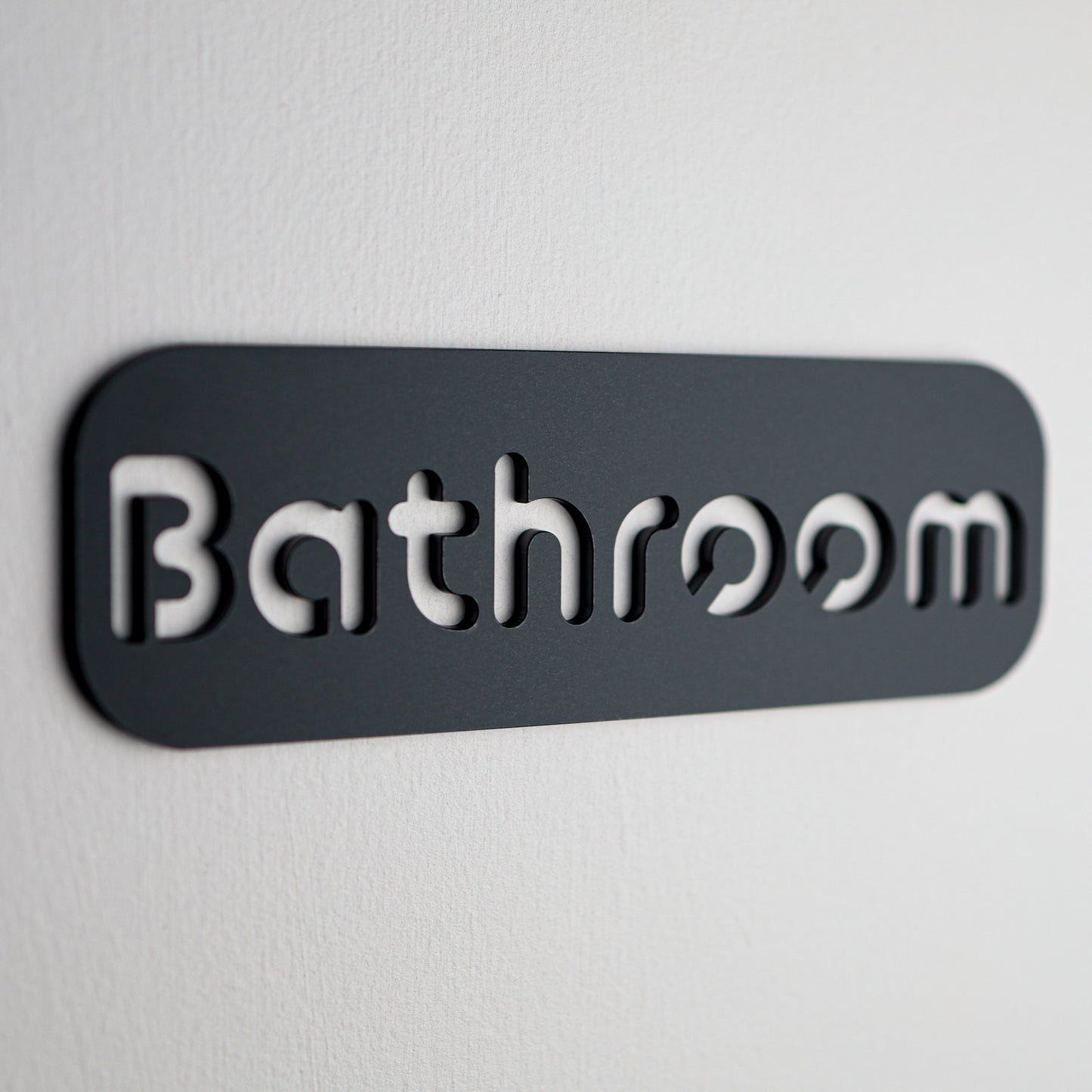 Elegant black "Bathroom" wall sign made from premium Stone Texture acrylic.