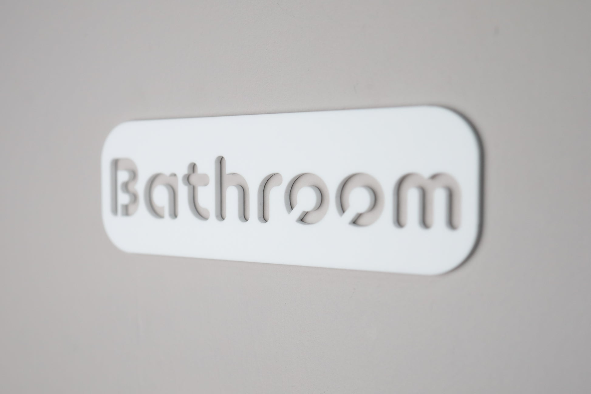 Elegant acrylic bathroom wall sign with cut-out letters and sleek black finish