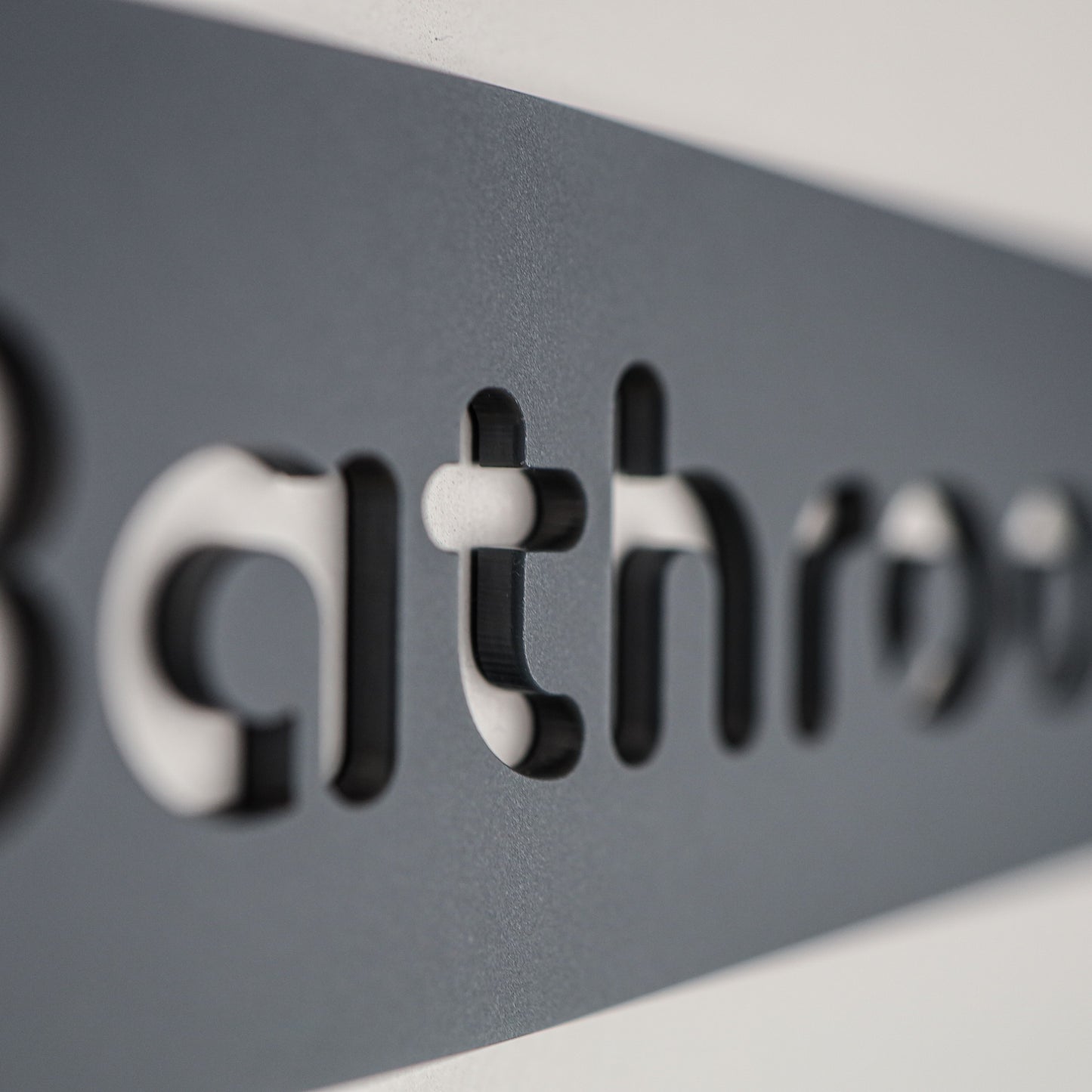 Stylish grey acrylic bathroom sign with sleek black font for modern interiors