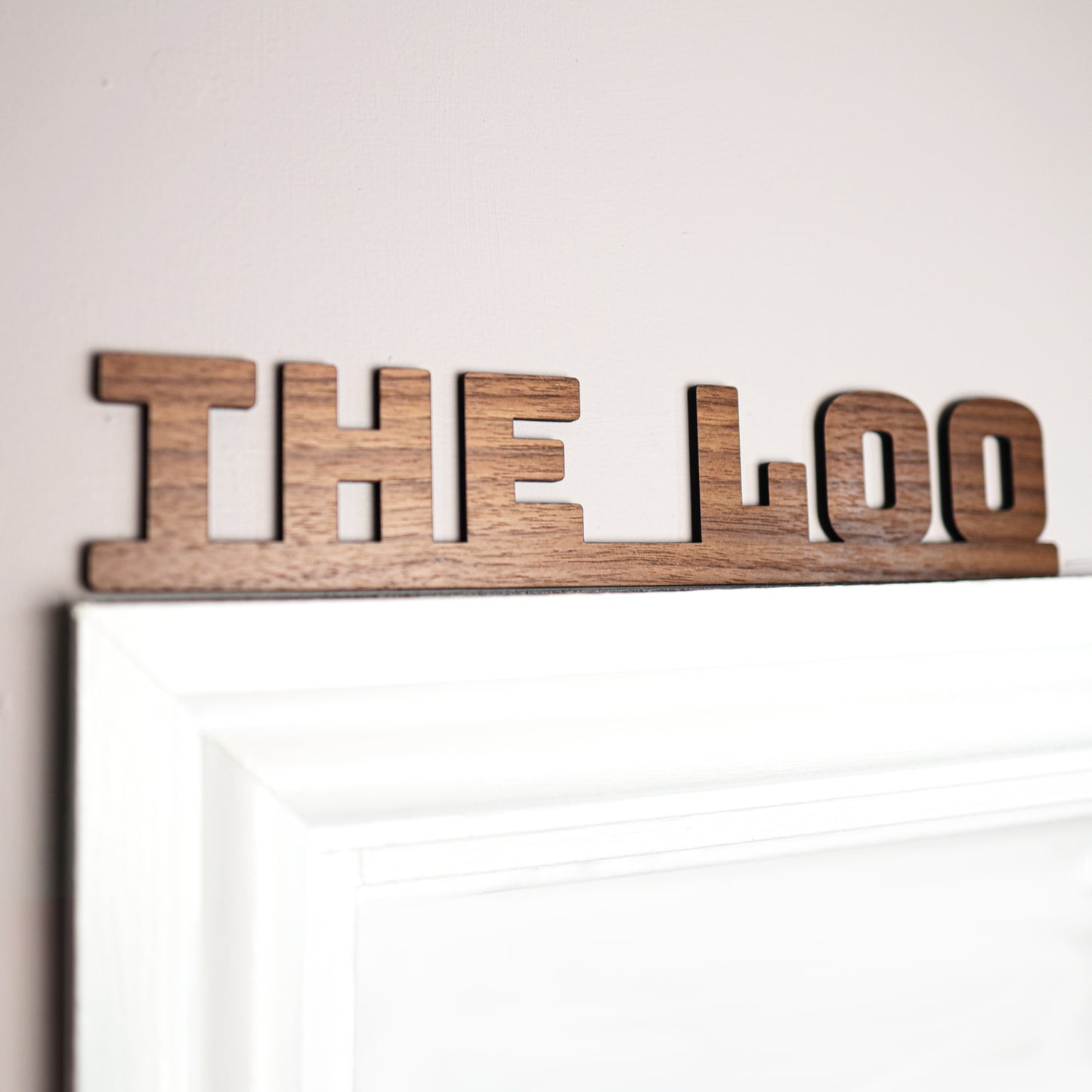 The loo sign made from walnut wood