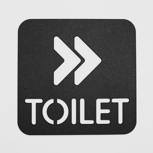 Modern black toilet directional sign with white arrows