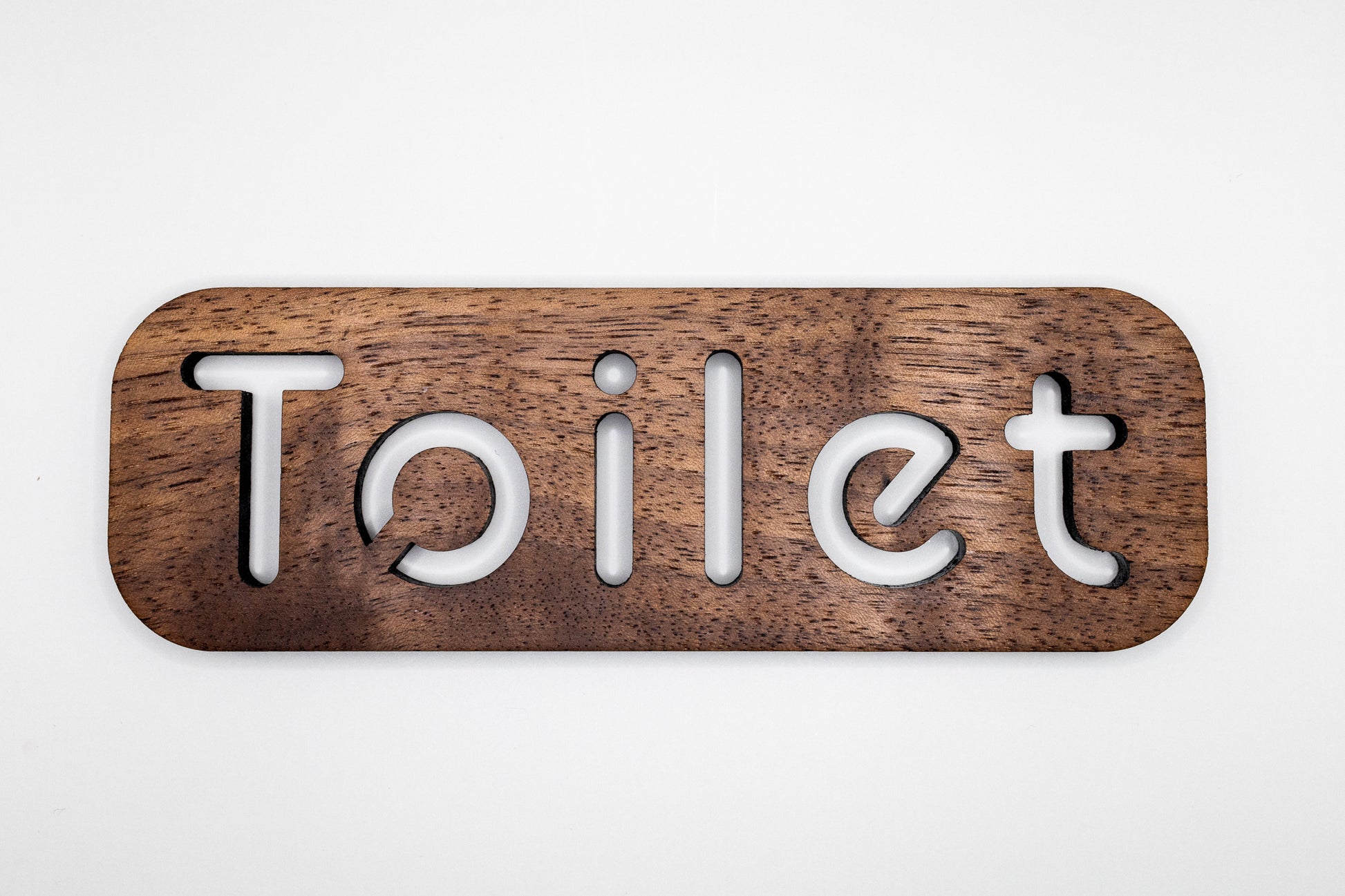 Toilet door sign made from walnut the sign reads toilet